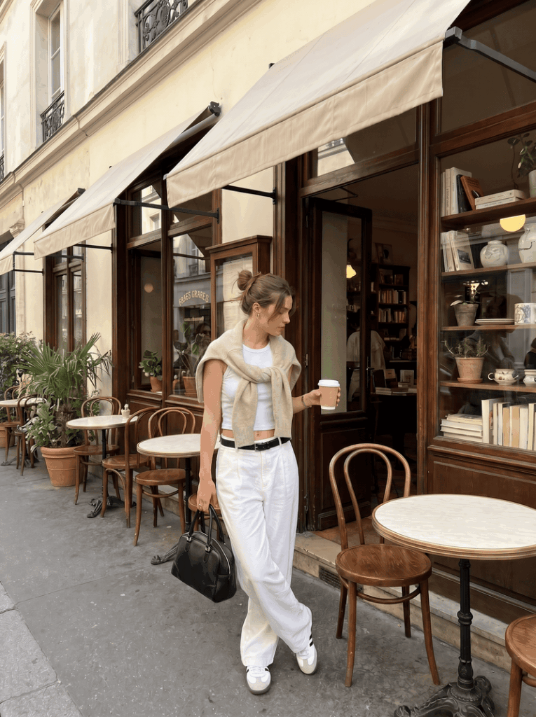 Fashion model in lifestyle scene generated by AI background changer for clothing.